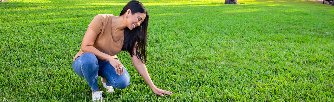 Homeowner looking at healthy turf