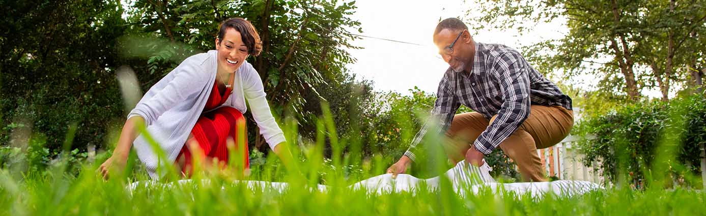 family eating picnic on healthy lawn